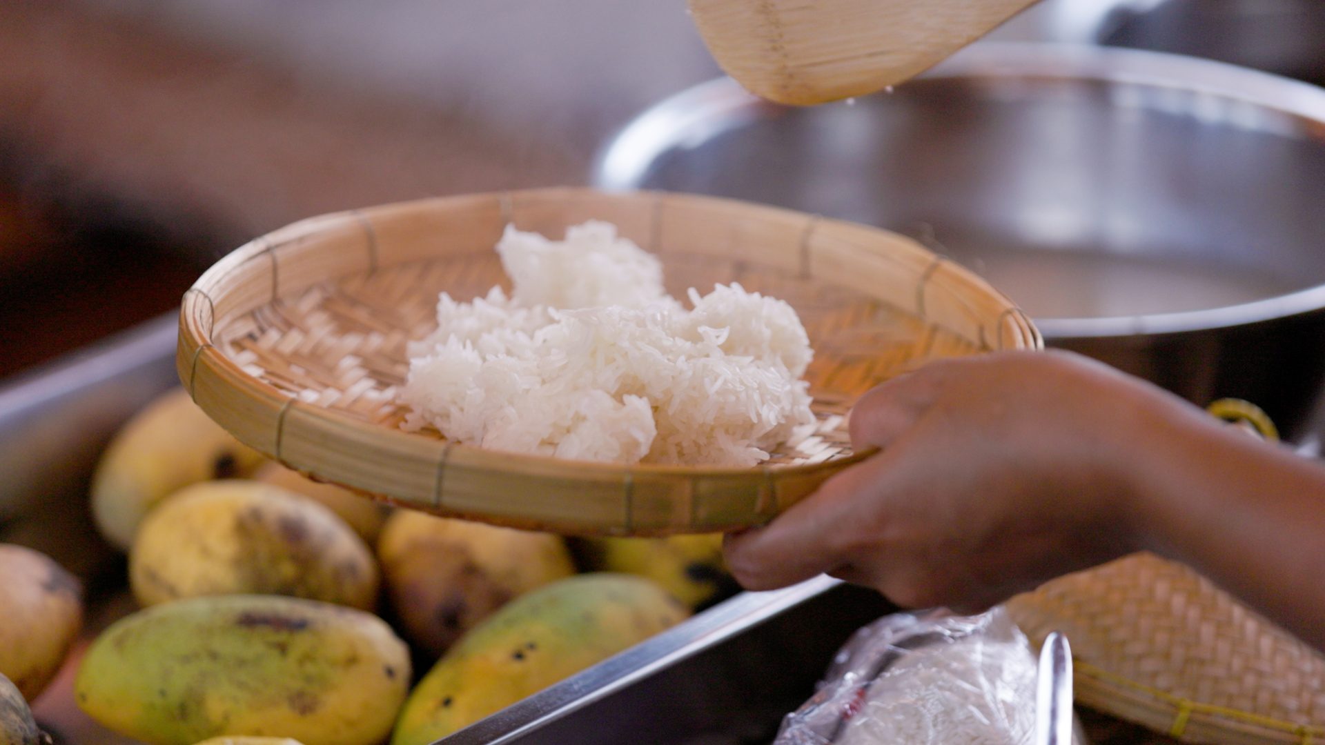 Sticky rice steaming, mangoes waiting